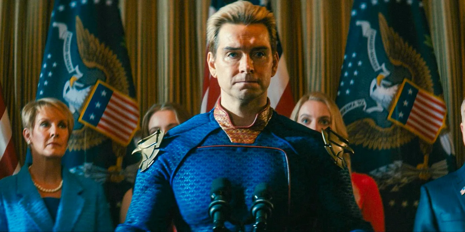 Homelander speaking at a podium about superheroes bringing justice to the country in The Boys Season 4, Episode 8 Image