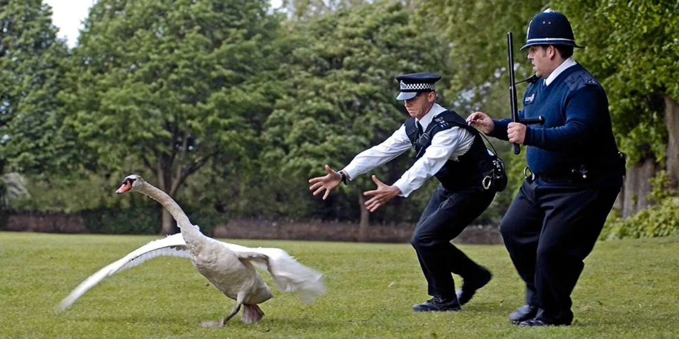 Hot Fuzz Sergeant Angel and Danny chasing a swan on a field Image