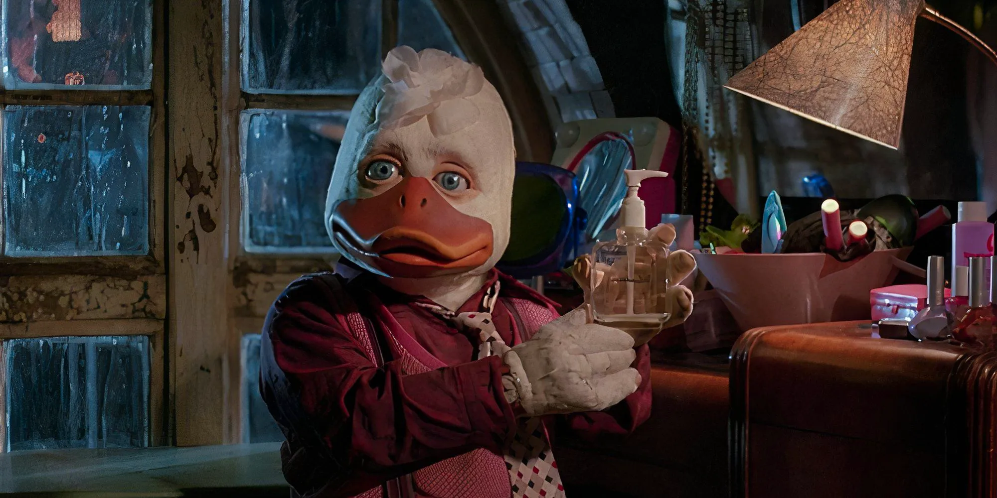 Howard holding a bottle of hand soap in Howard The Duck. Image