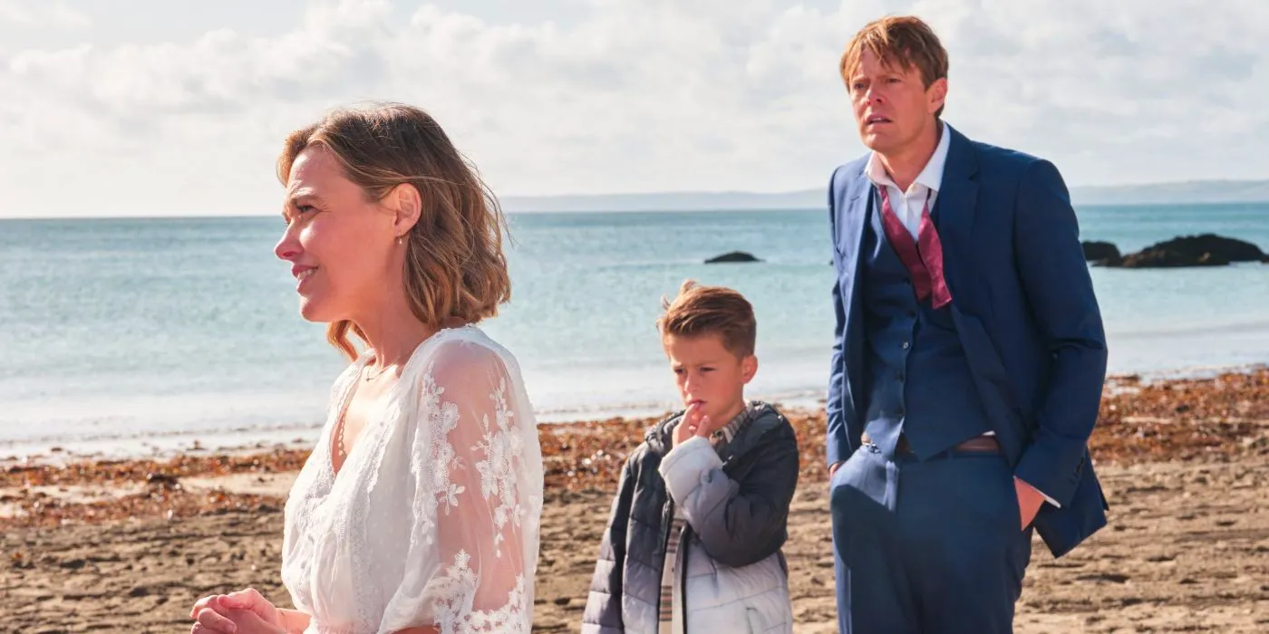 Humphrey (Kris Marshall) and Martha (Sally Bretton) walking on the beach with a young boy in Beyond Paradise. Image