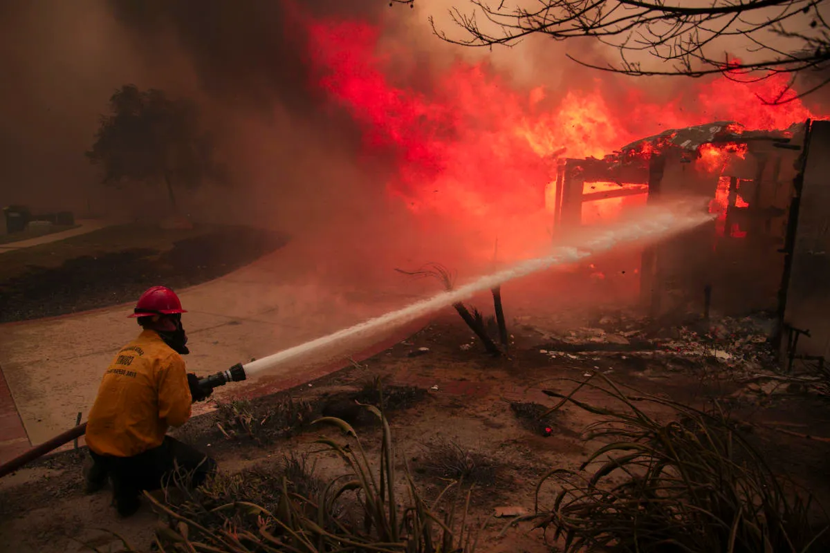 Hundreds flee and homes burn as powerful winds feed wildfires in Southern California Image