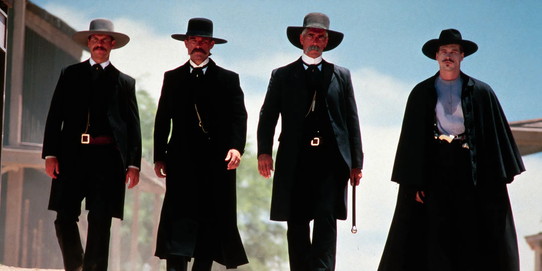 Iconic still from the movie Tombstone featuring Val Kilmer, Bill Paxton, Sam Elliott, and Kurt Russell as the Earps and Doc Holliday. Image