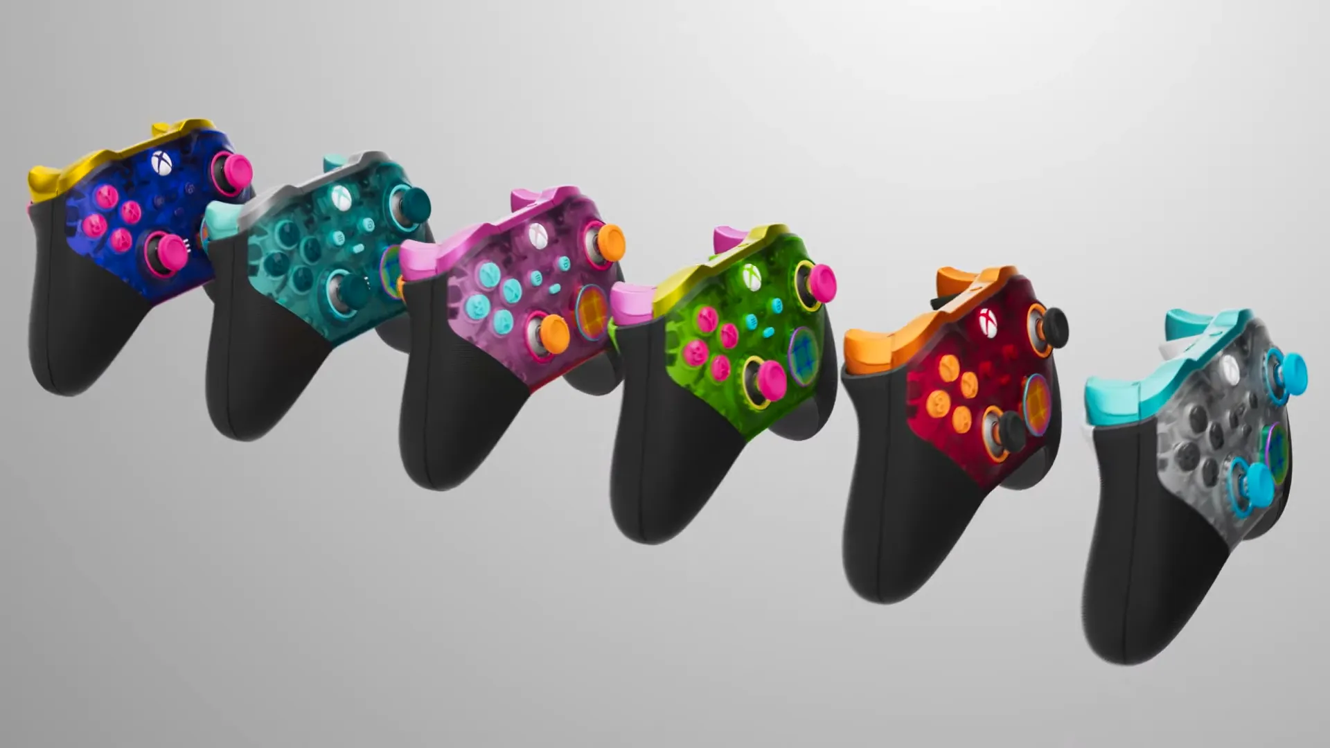 Image of all 6 of the new xbox controllers lined up, inclduing blue, red, green. pink., light blue and purple.  Image