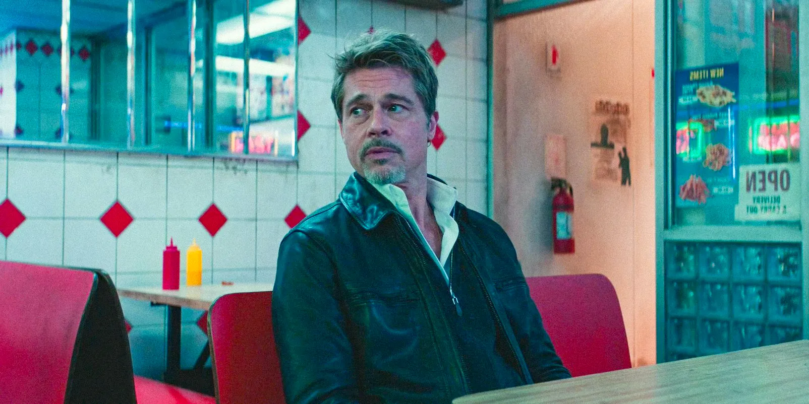 In a restaurant, Pam's Man (Brad Pitt) looking alertly around him in WOLFS Image