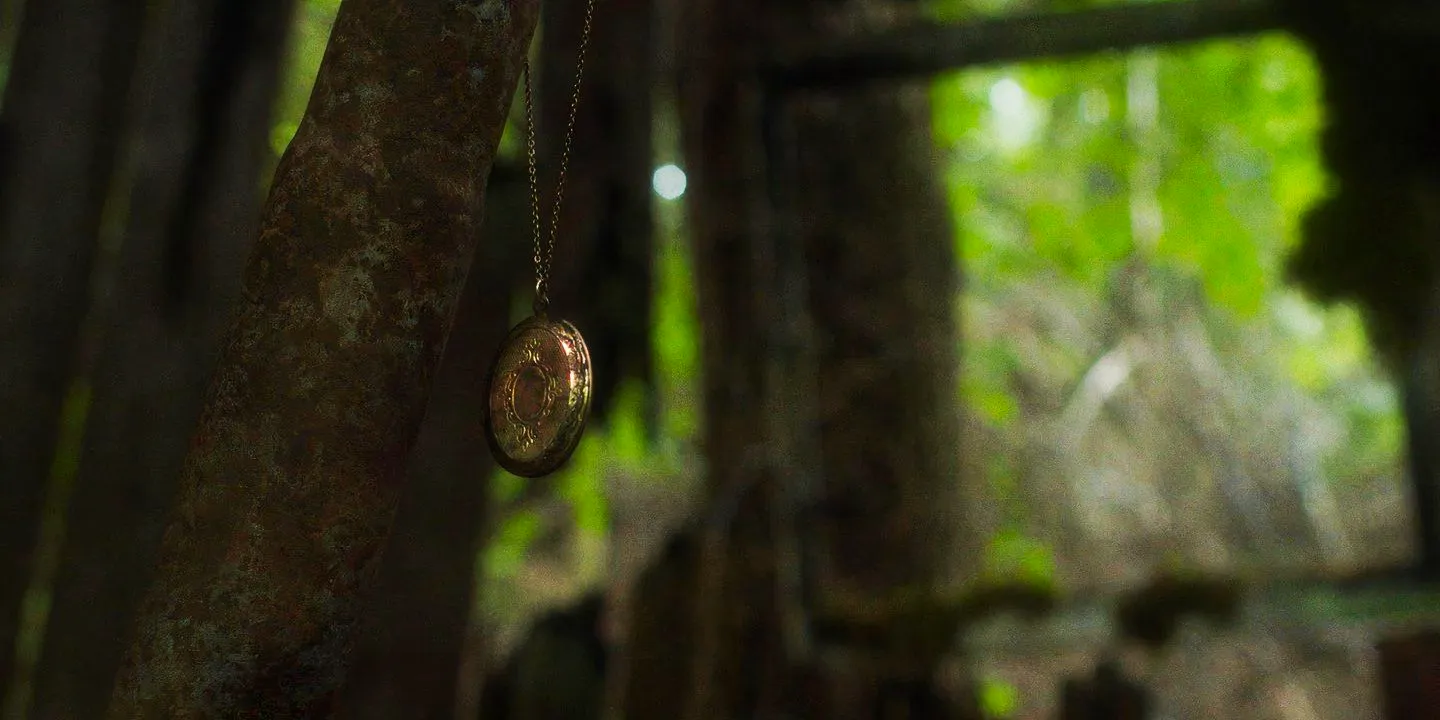 In A Violent Nature golden locket over Johnny's grave at the fire tower Image