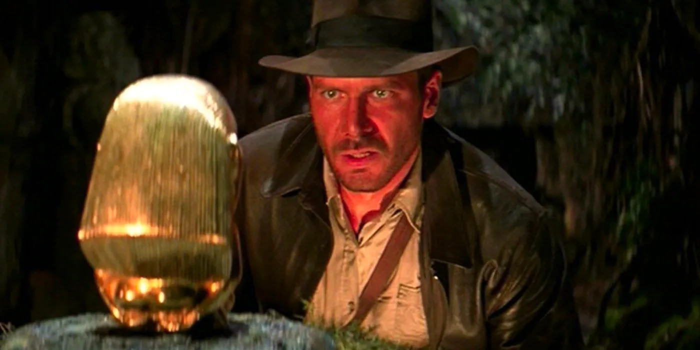 Indiana Jones (Harrison Ford) looking at the artifact in Raiders of the Lost Ark Image