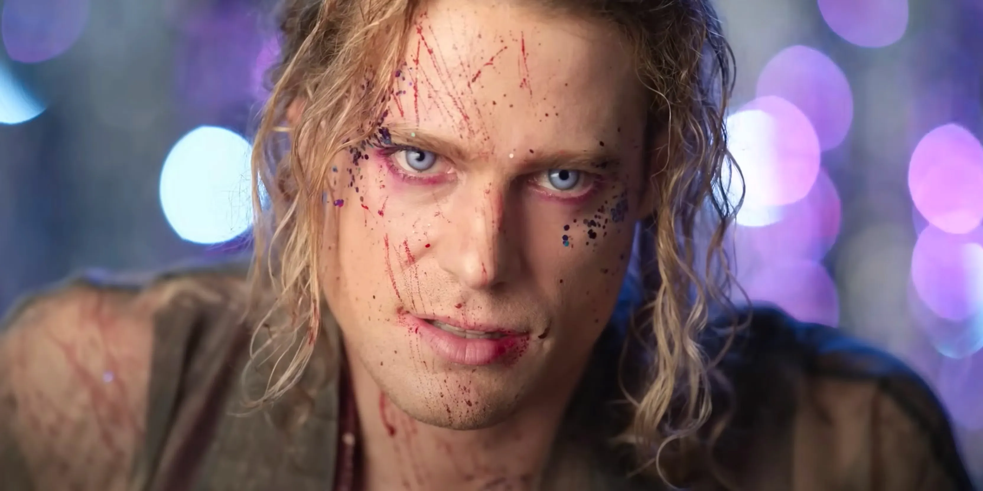 Interview with the Vampire Lestat with fangs and glitter and blood on his face in season 3 trailer. Image