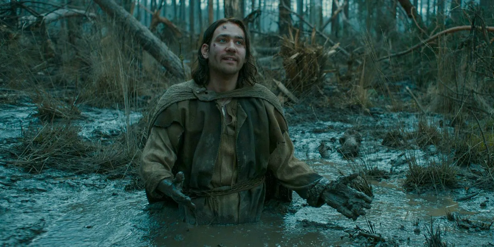 Isildur (Maxim Baldry) trapped in quicksand in The Lord of the Rings: The Rings of Power Season 2 Episode 4 Image