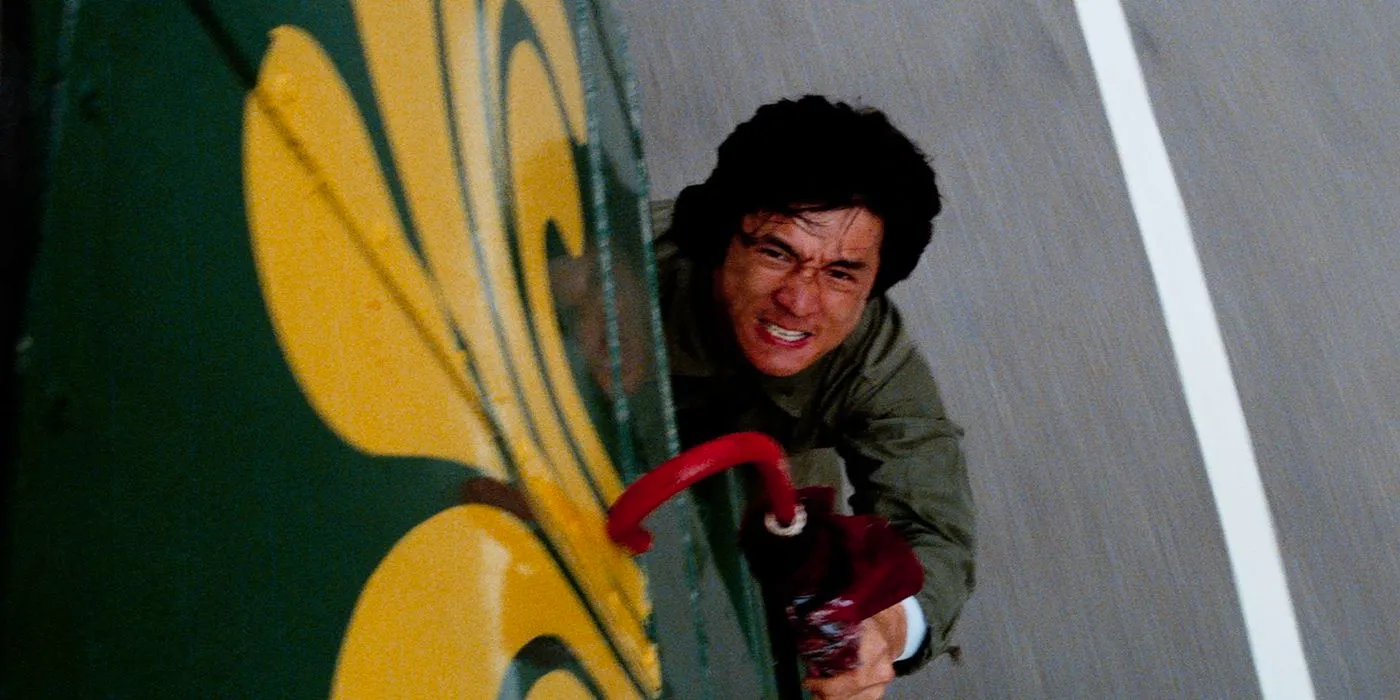 Jackie Chan on the outside of a bus in Police Story Image