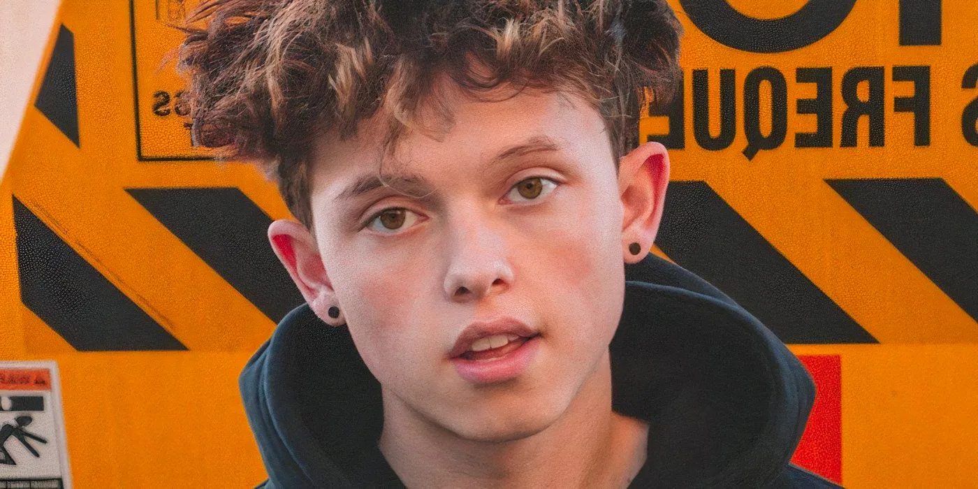 Jacob Sartorius posing in front of a warning sign Image