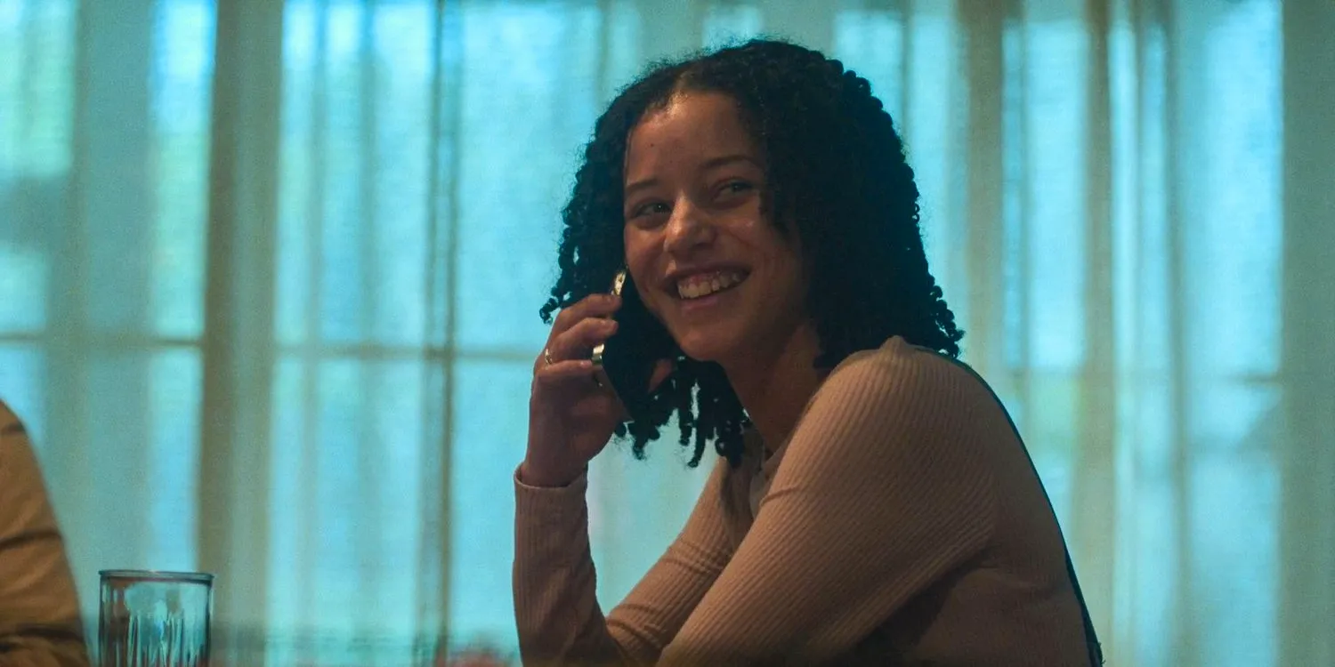 Jaden (Chase Infiniti) smiles as she answers a phone call in Presumed Innocent season 1 episode 5 Image