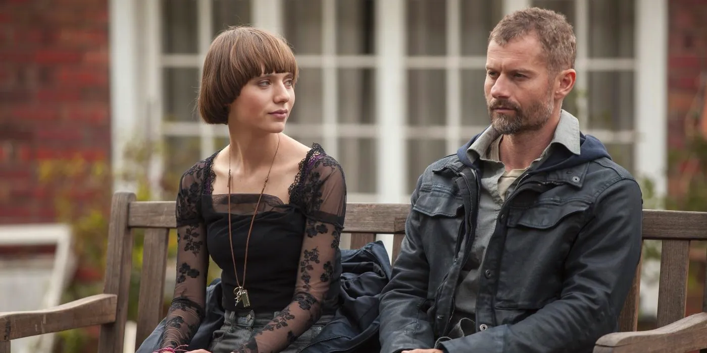 James Badge Dale and Sasha Frolova sit on a bench in The Empty Man Image