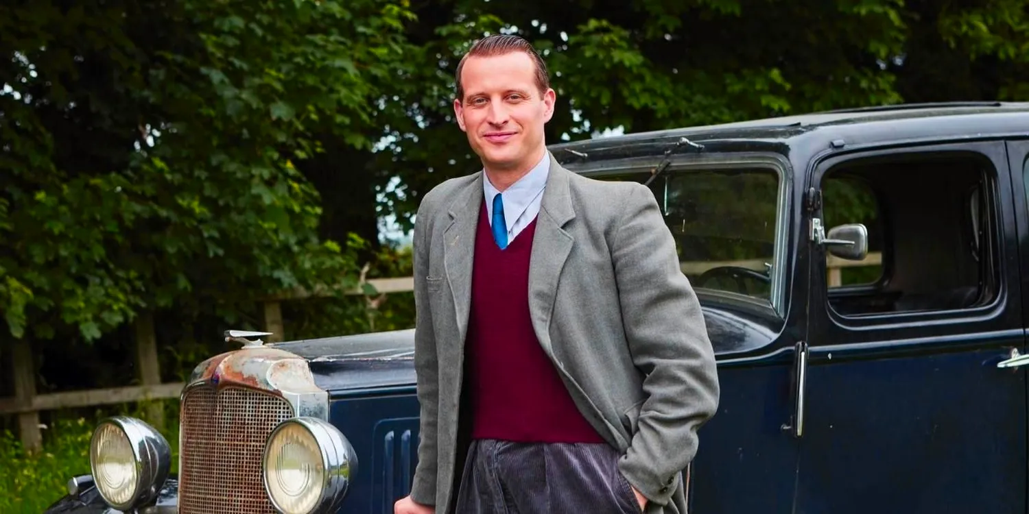 James leaning against a car and smiling in All Creatures Great and Small Image