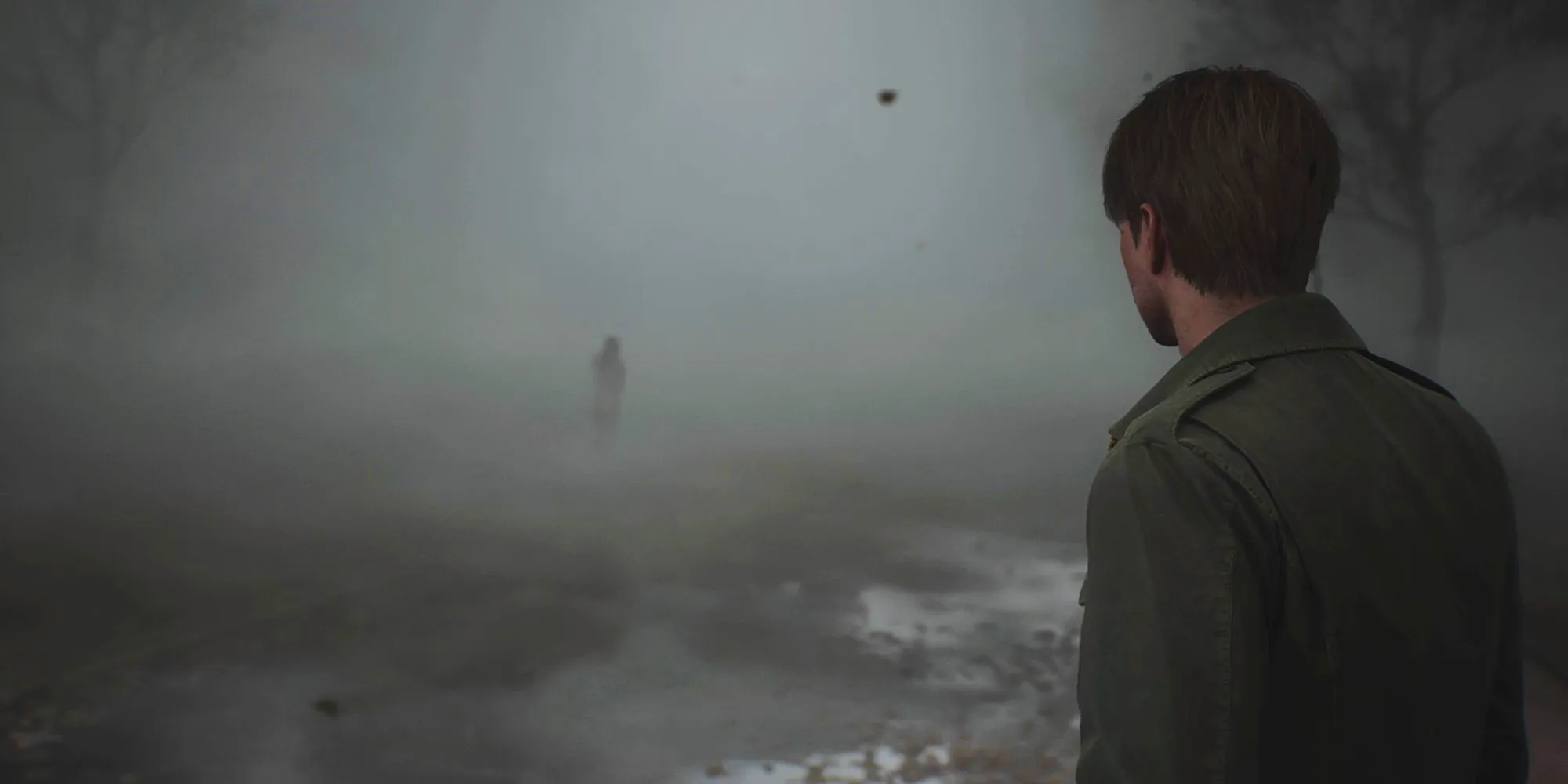 James stares at a shadowy form shrouded in fog in a screenshot from the Silent Hill 2 remake. Image