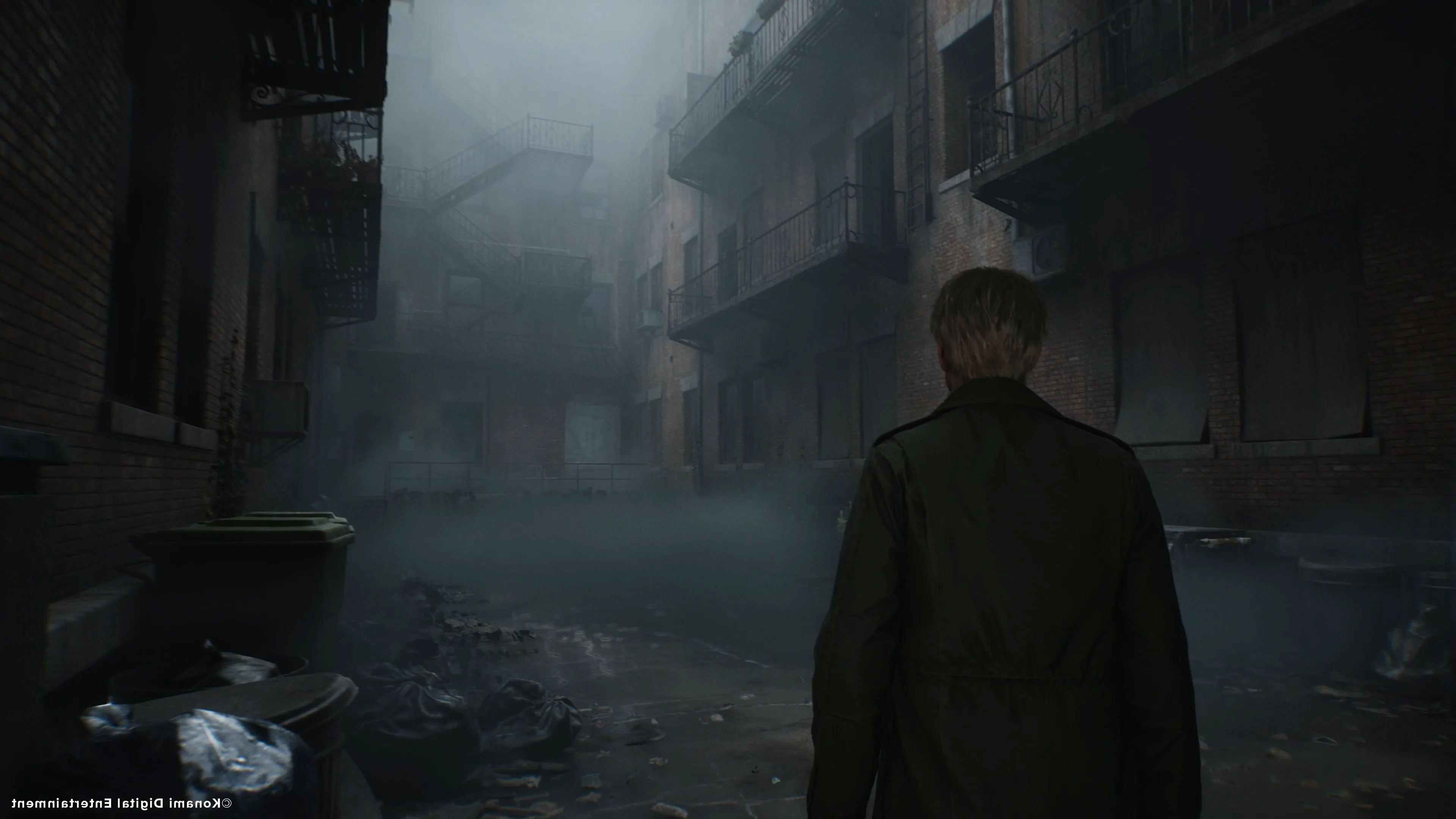 James walking through an apartment alleyway in Silent Hill 2 Image