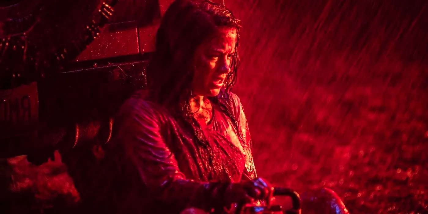 Jane Levy sitting on the ground covered in raining blood in Evil Dead 2013 Image