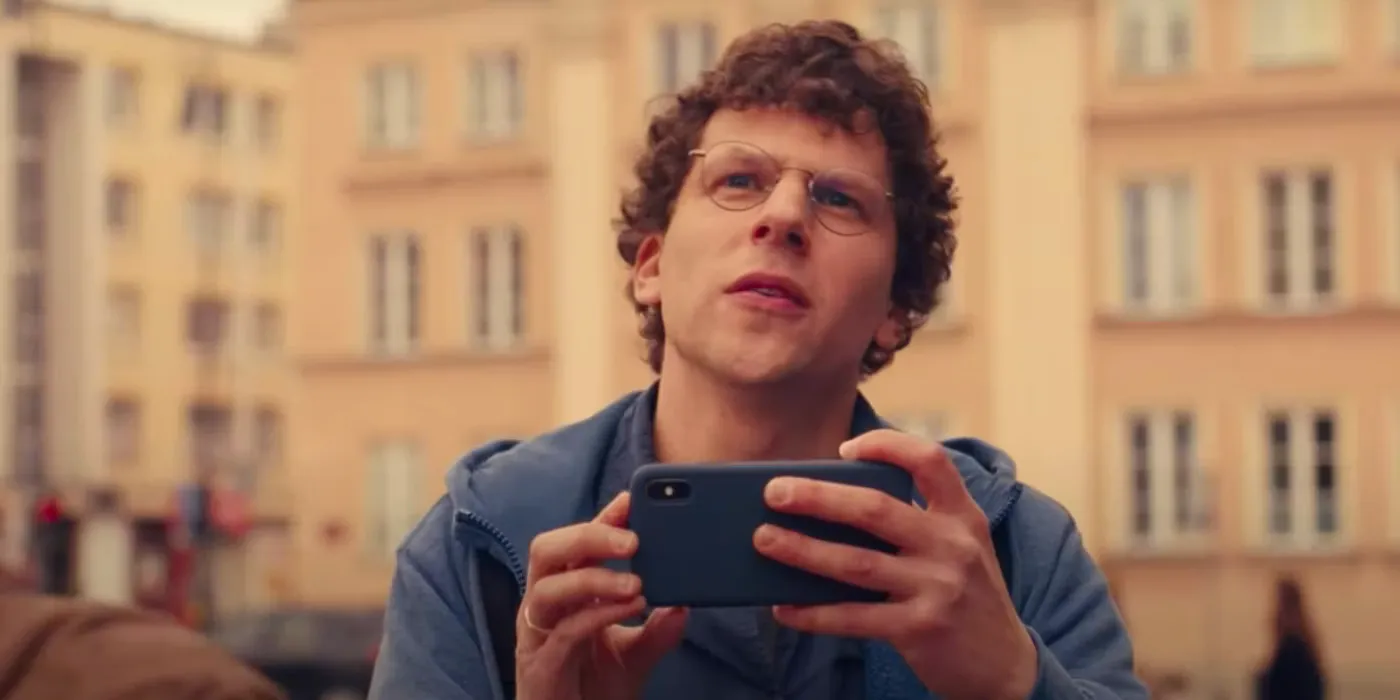 Jesse Eisenberg taking a picture in A Real Pain Image