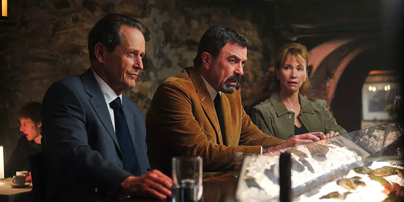 Jesse Stone sitting at a bar between a man and a woman in Innocents Lost. Image