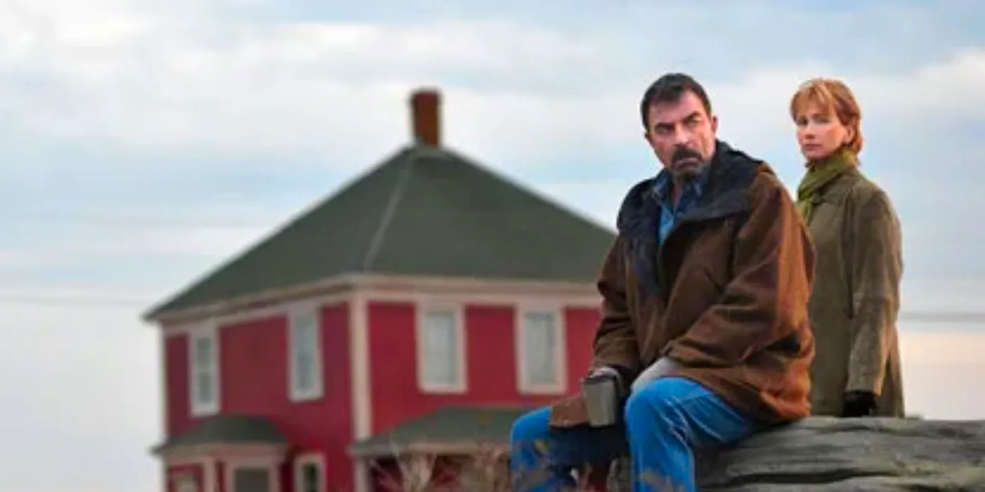 Jesse Stone sitting on a pier with a woman behind him Image