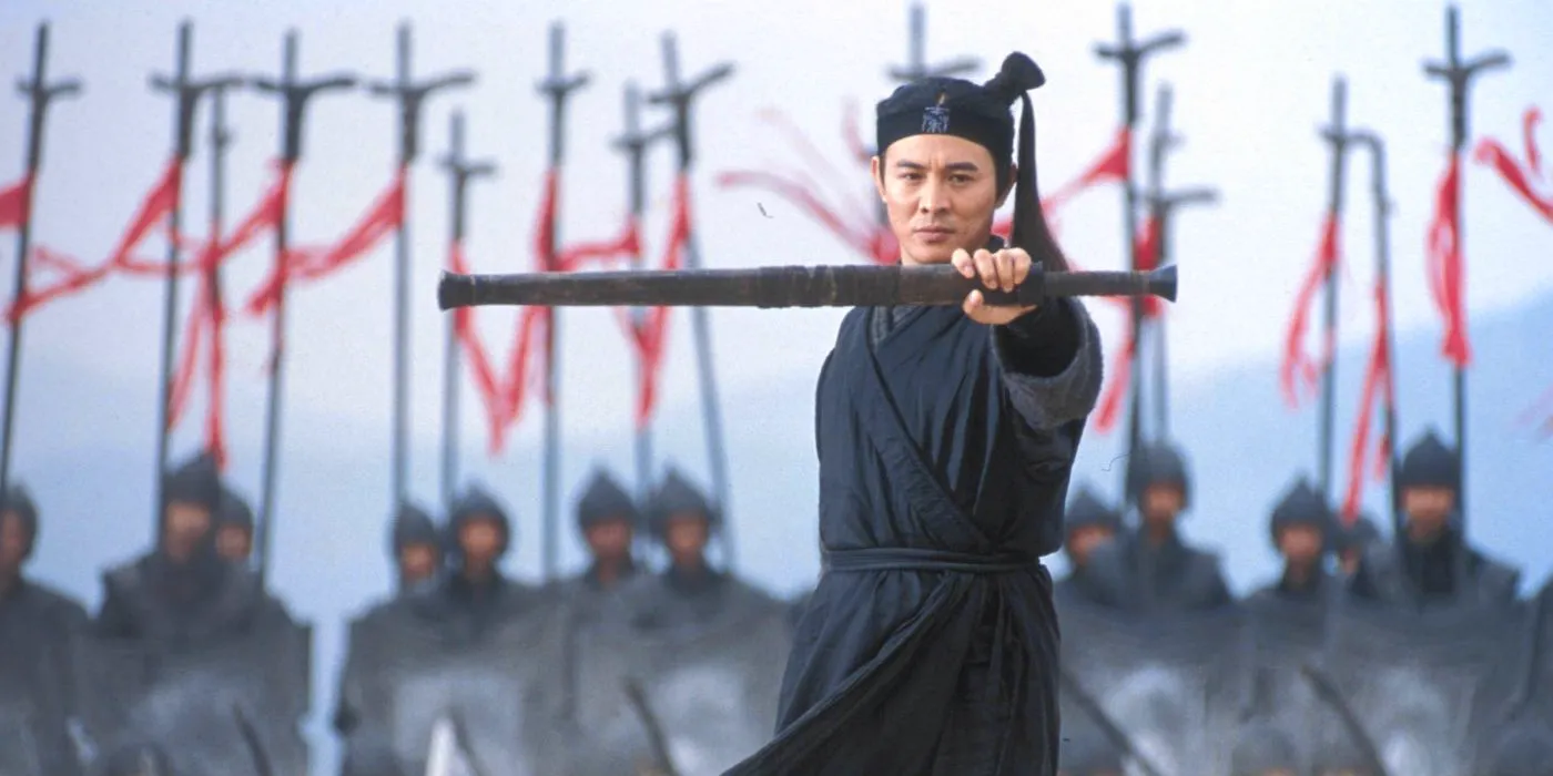 Jet Li with hold up his sheathed sword in the film Hero. Image