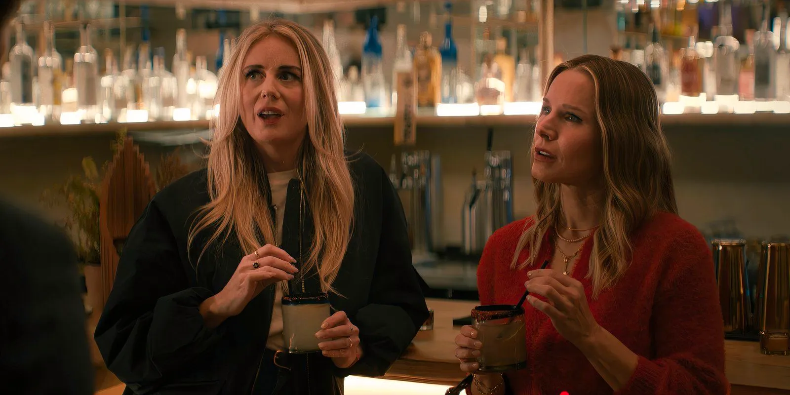 Joanne and Morgan hold drinks at the bar in Nobody Wants This season 1 episode 2 Image