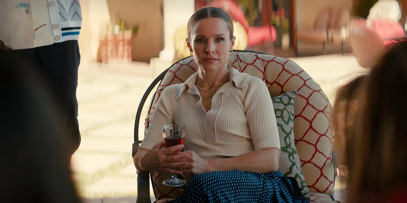 Joanne sits outside holding a wine glass in Nobody Wants This episode 9 Image