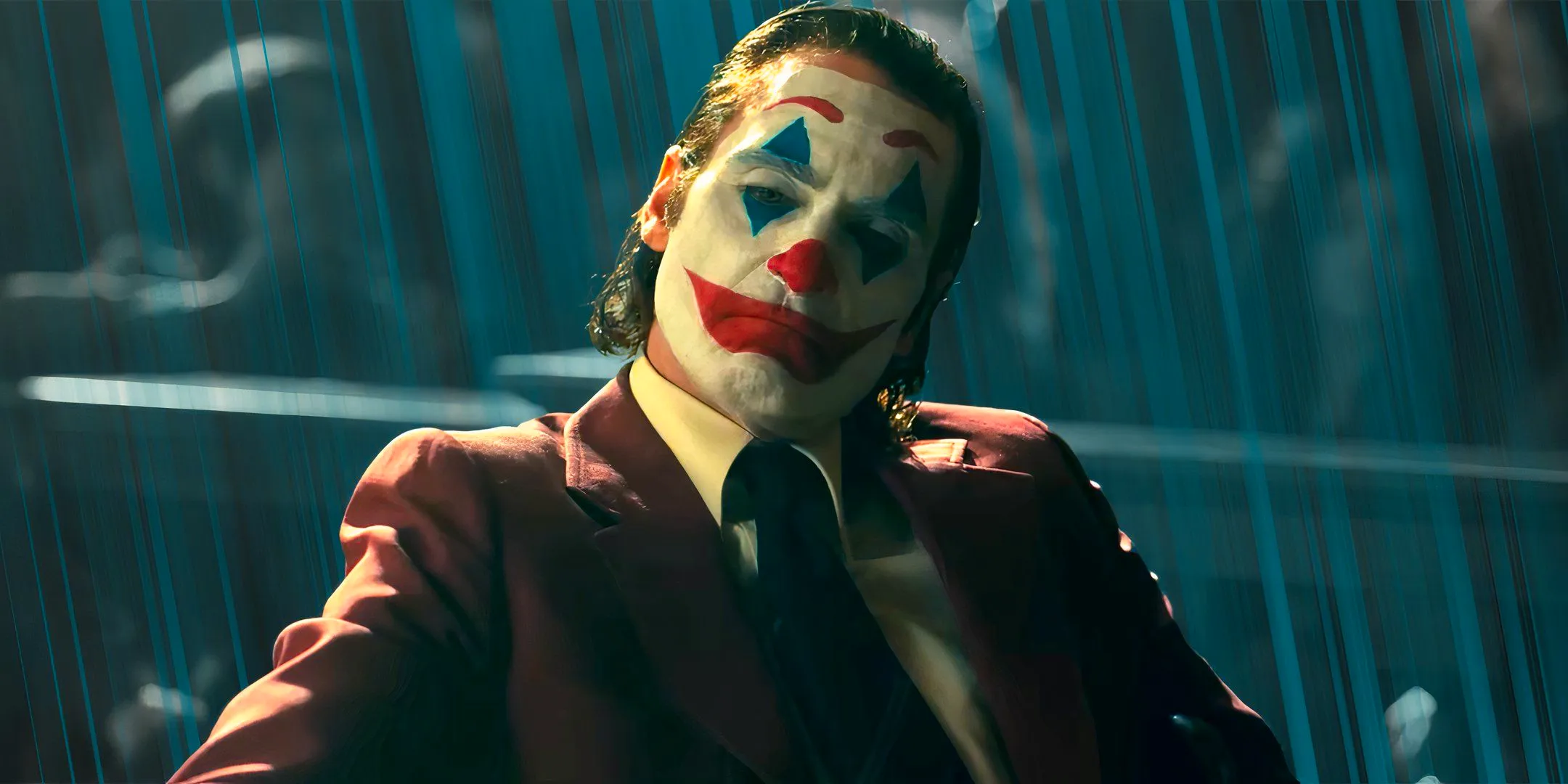 Joaquin as Arthur Fleck making a sad face in clown makeup in Joker: Folie à Deux Image