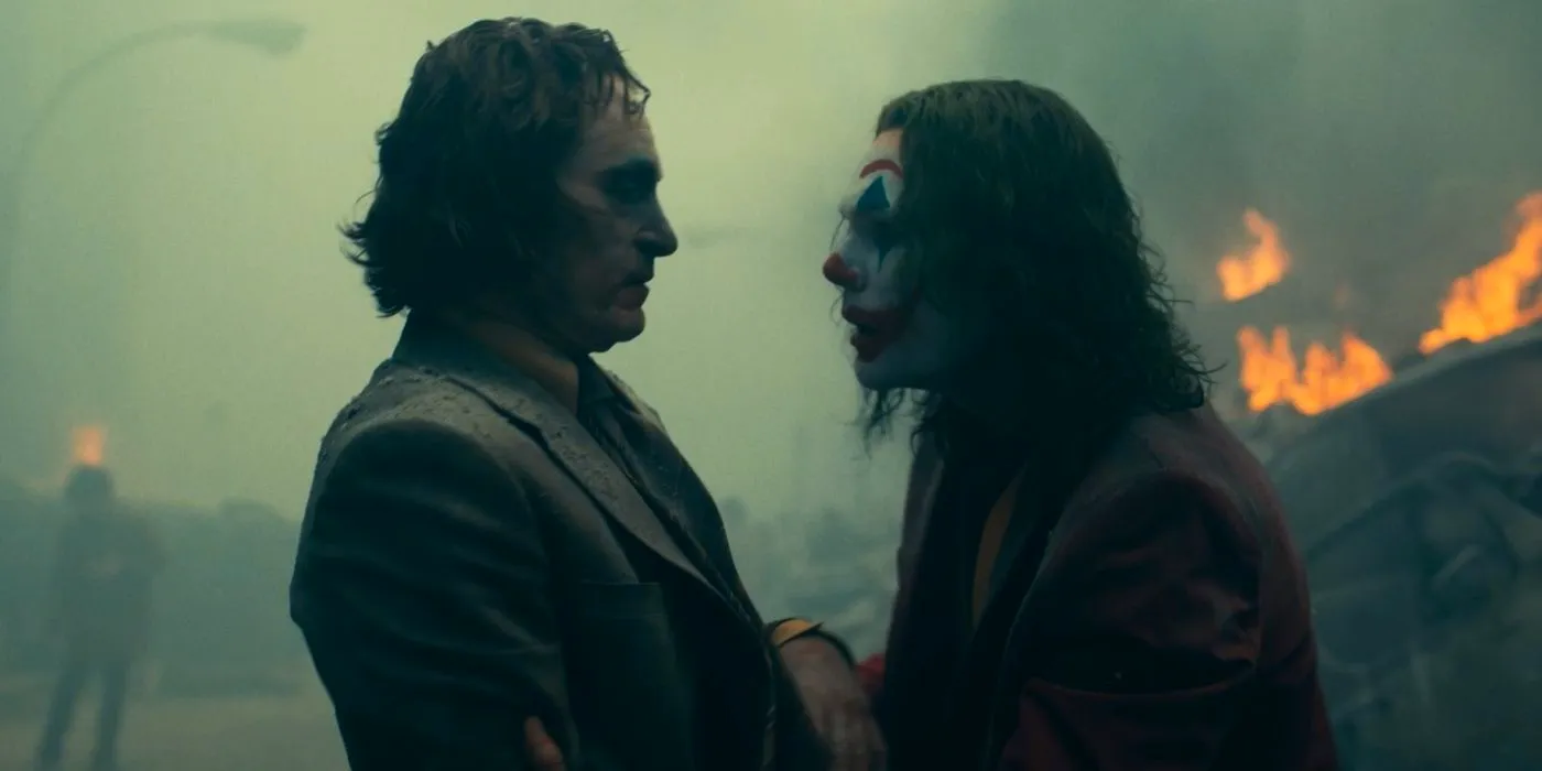 Joaquin Phoenix as Joker and Arthur Fleck looking at one another Image