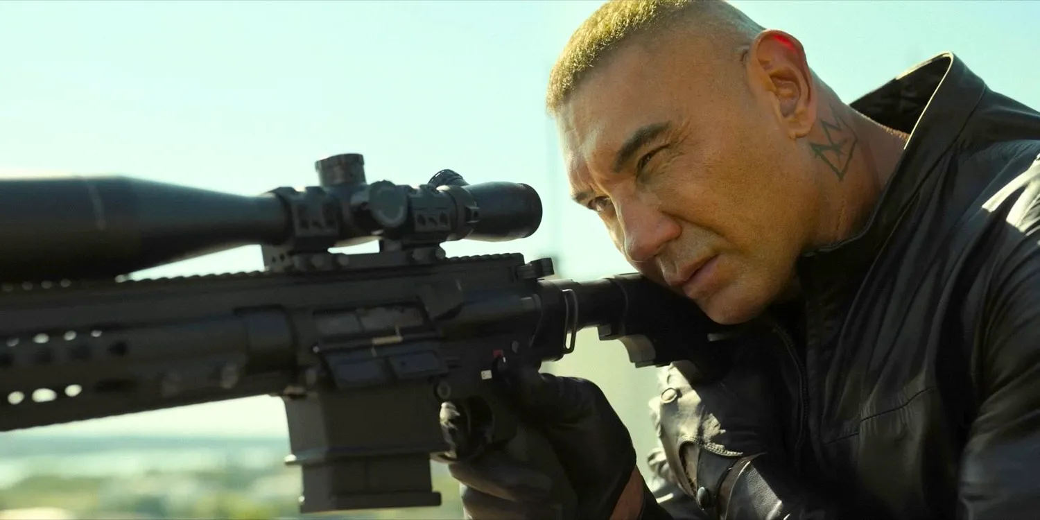 Joe Flood (Dave Bautista) with blond hair, as a sniper in The Killer's Game (2024) Image