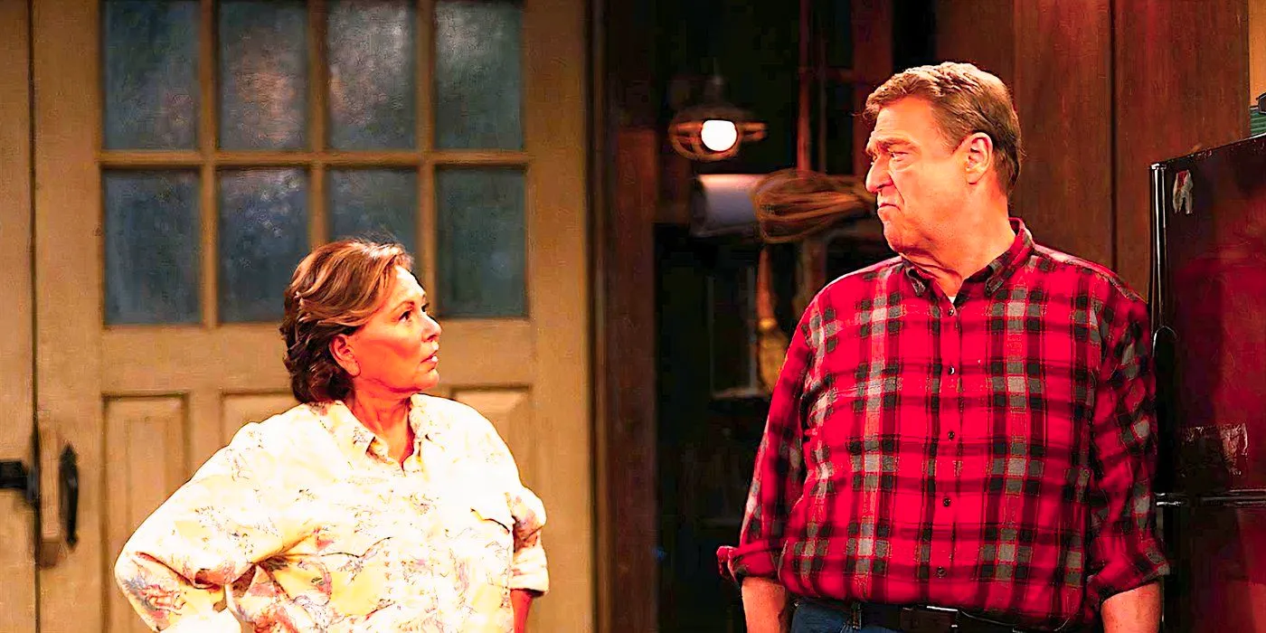 John Goodman's Dan frowns as Roseanne Barr's Roseanne looks shocked in Roseanne season 10. Image