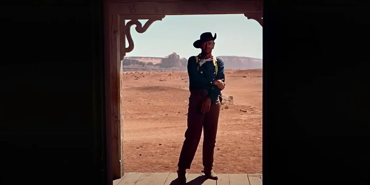 John Wayne as Ethan standing in the doorway in The Searchers  Image