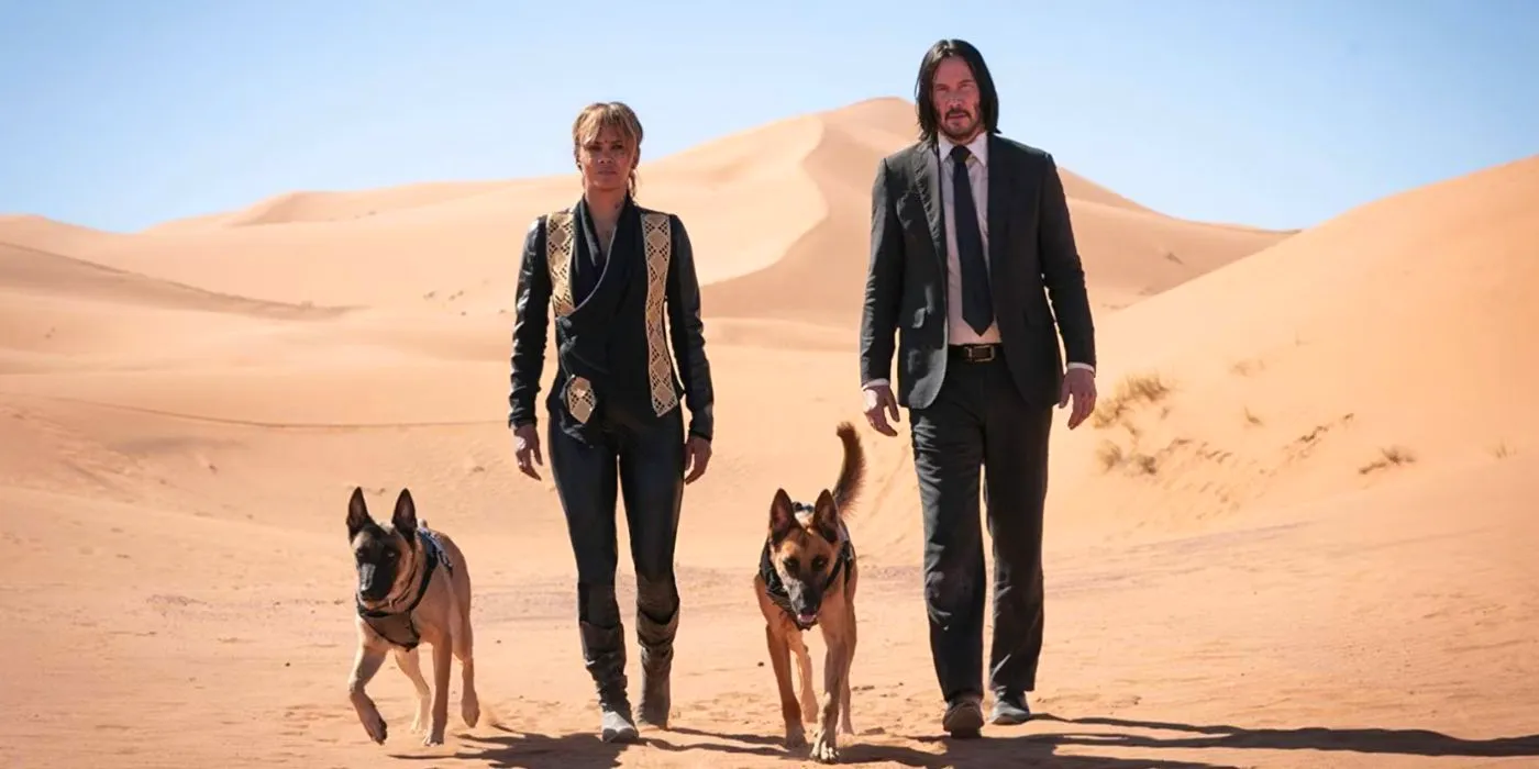 John Wick and Sofia walking with dogs in the desert in John Wick 3 Image