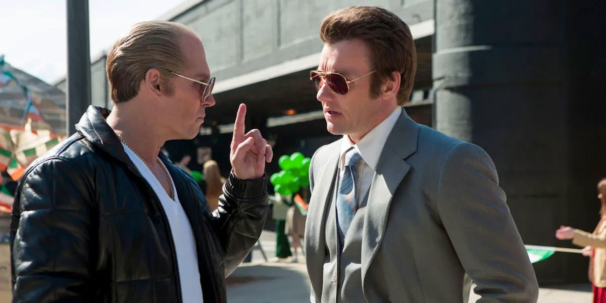 Johnny Depp pointing a finger to Joel Egerton in Black Mass Image