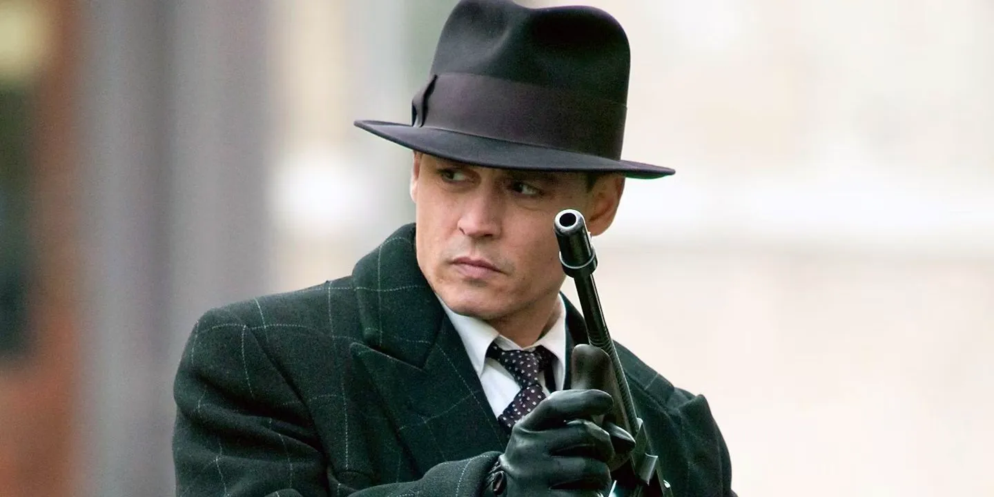 Johnny Depp with a machine gun in Public Enemies Image