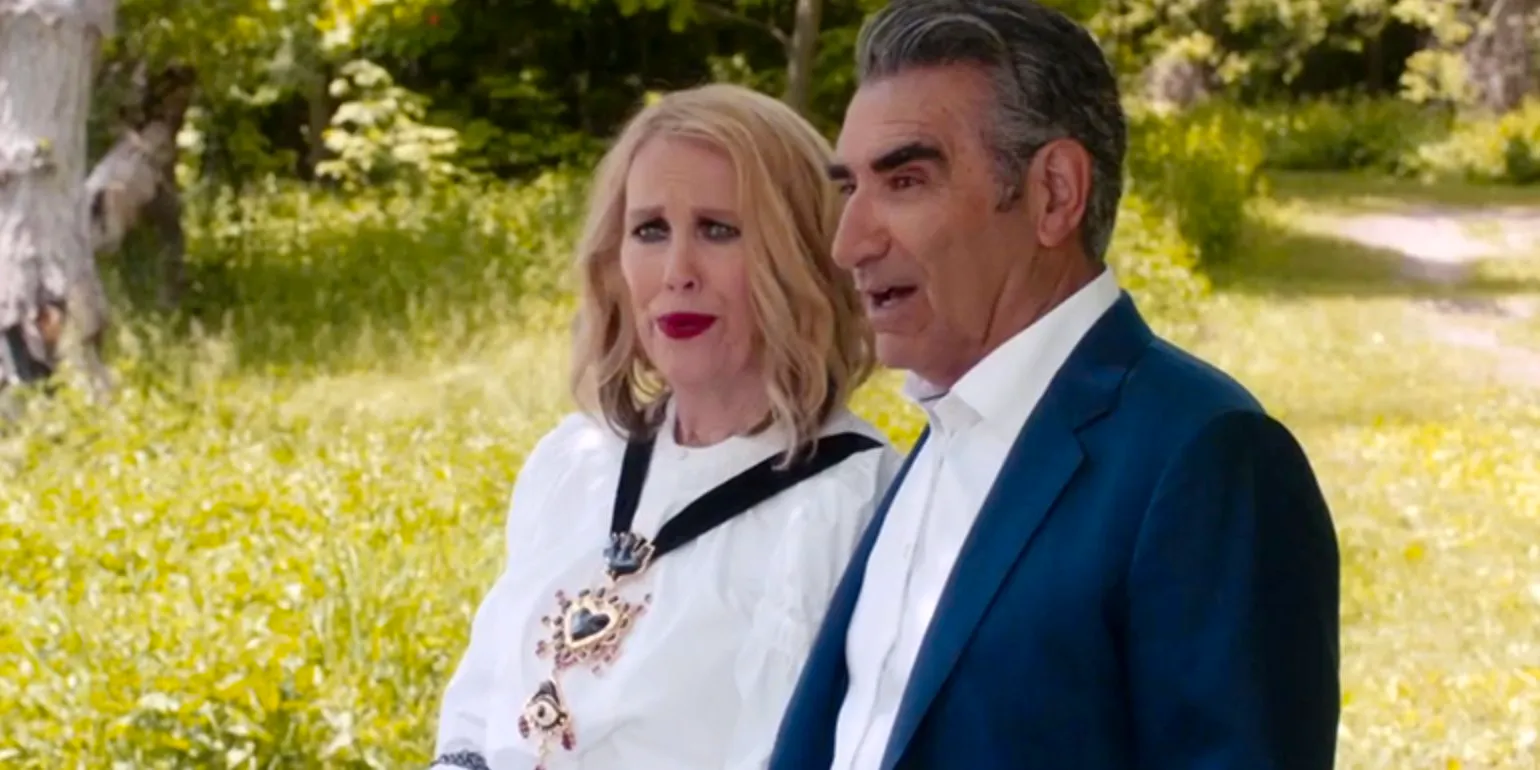 Johnny (Eugene Levy) And Moira (Eugene Levy) in a field in the sun in Schitts Creek Season 6 Premiere Image