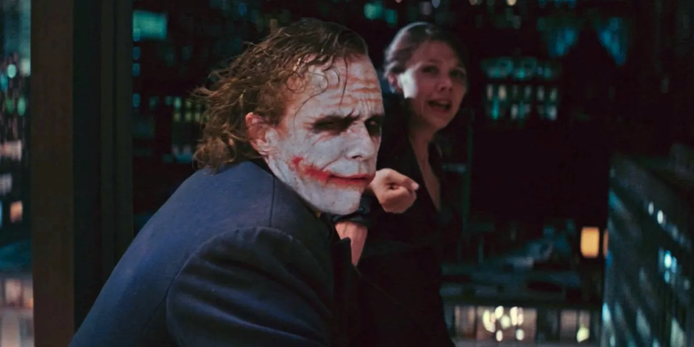 Joker (Heath Ledger) threatens Rachel (Maggie Gyllenhaal) in The Dark Knight Image