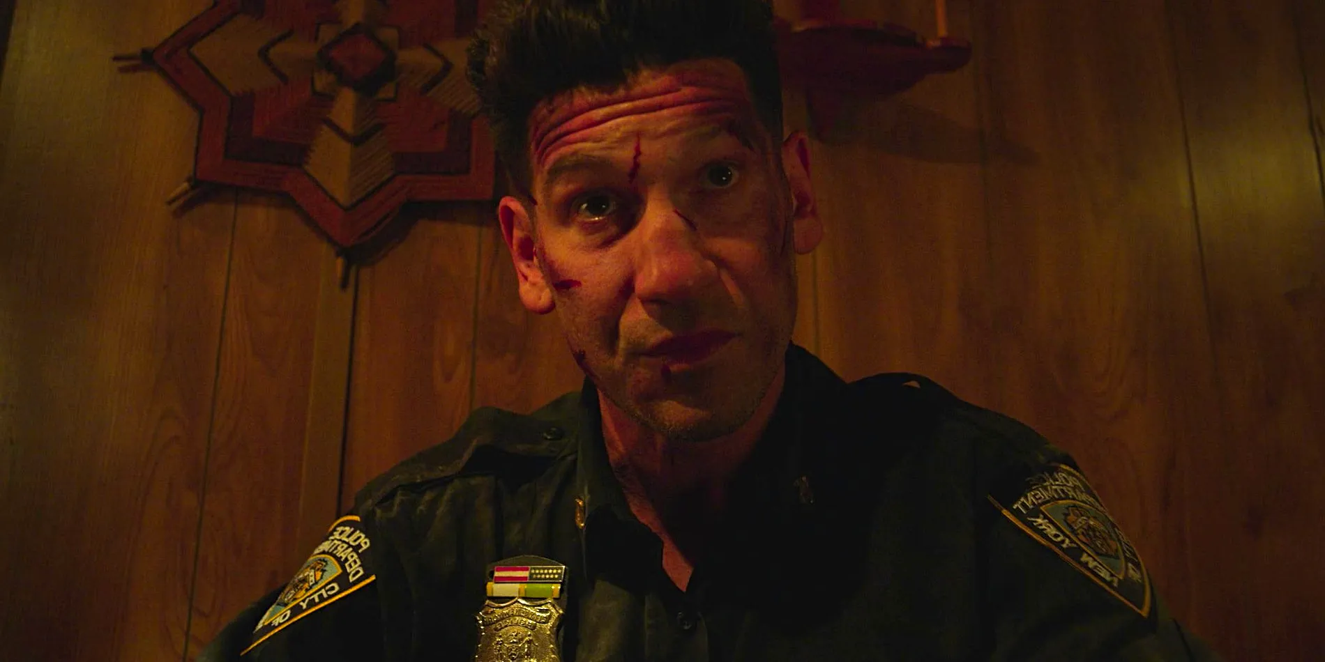 Jon Bernthal's Punisher bloody and bruised in a cop uniform in The Punisher season 2 finale Image