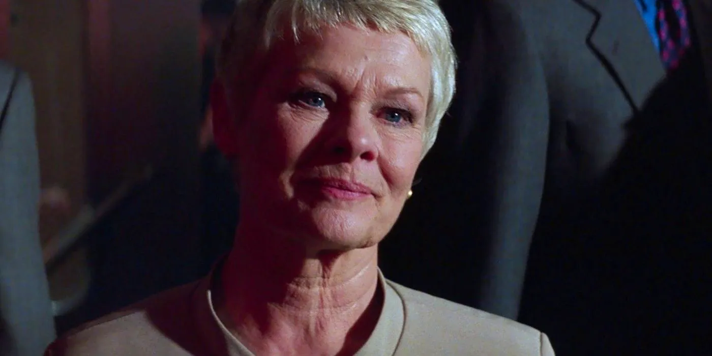 Judi Dench as M smiling in James Bond movie The World Is Not Enough. Image