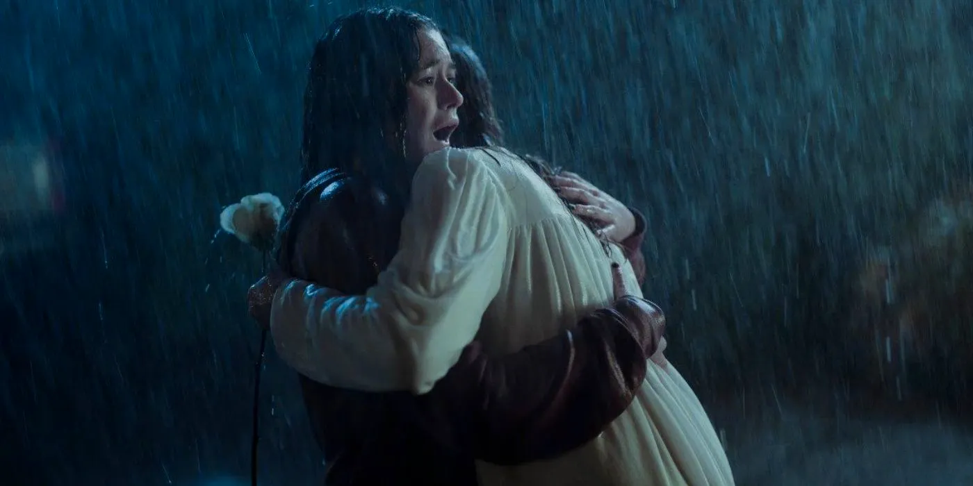 Jules hugs Mae in the rain in Devil in Ohio. Image