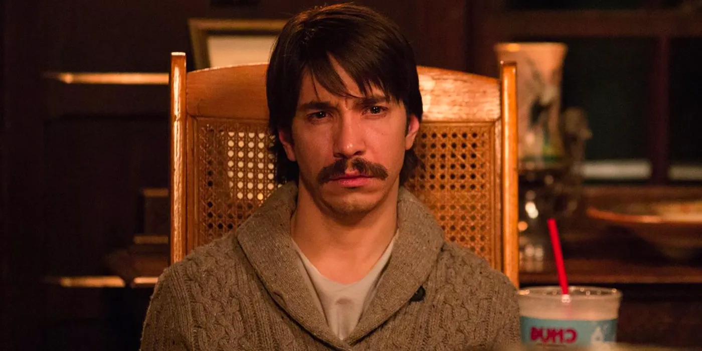 Justin Long as Wallace looking depressed while sitting in a chair in Tusk Image