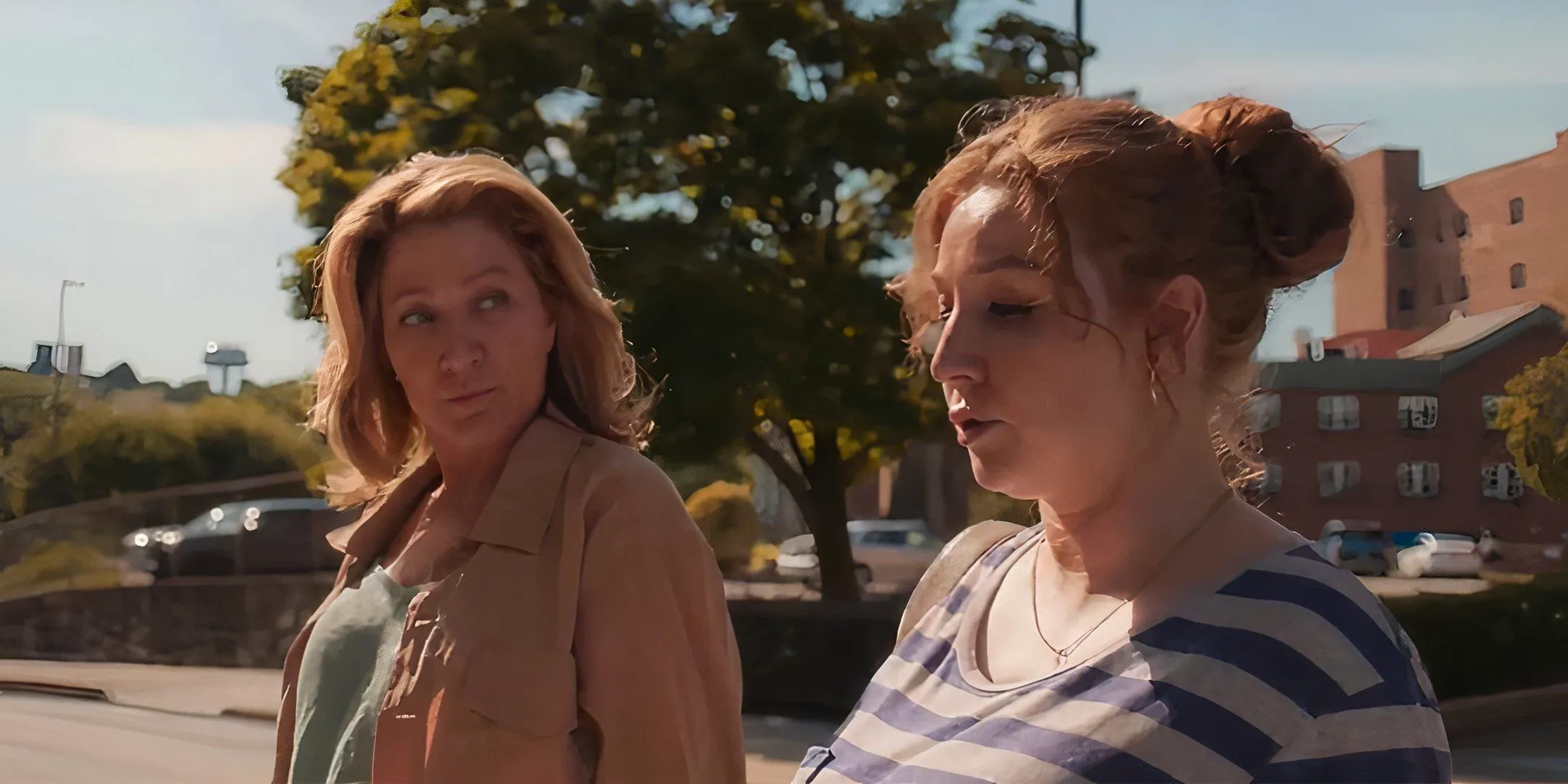 Kayli Carter as Sarah walking next to Edie Falco's Wanda in I'll Be Right There Image