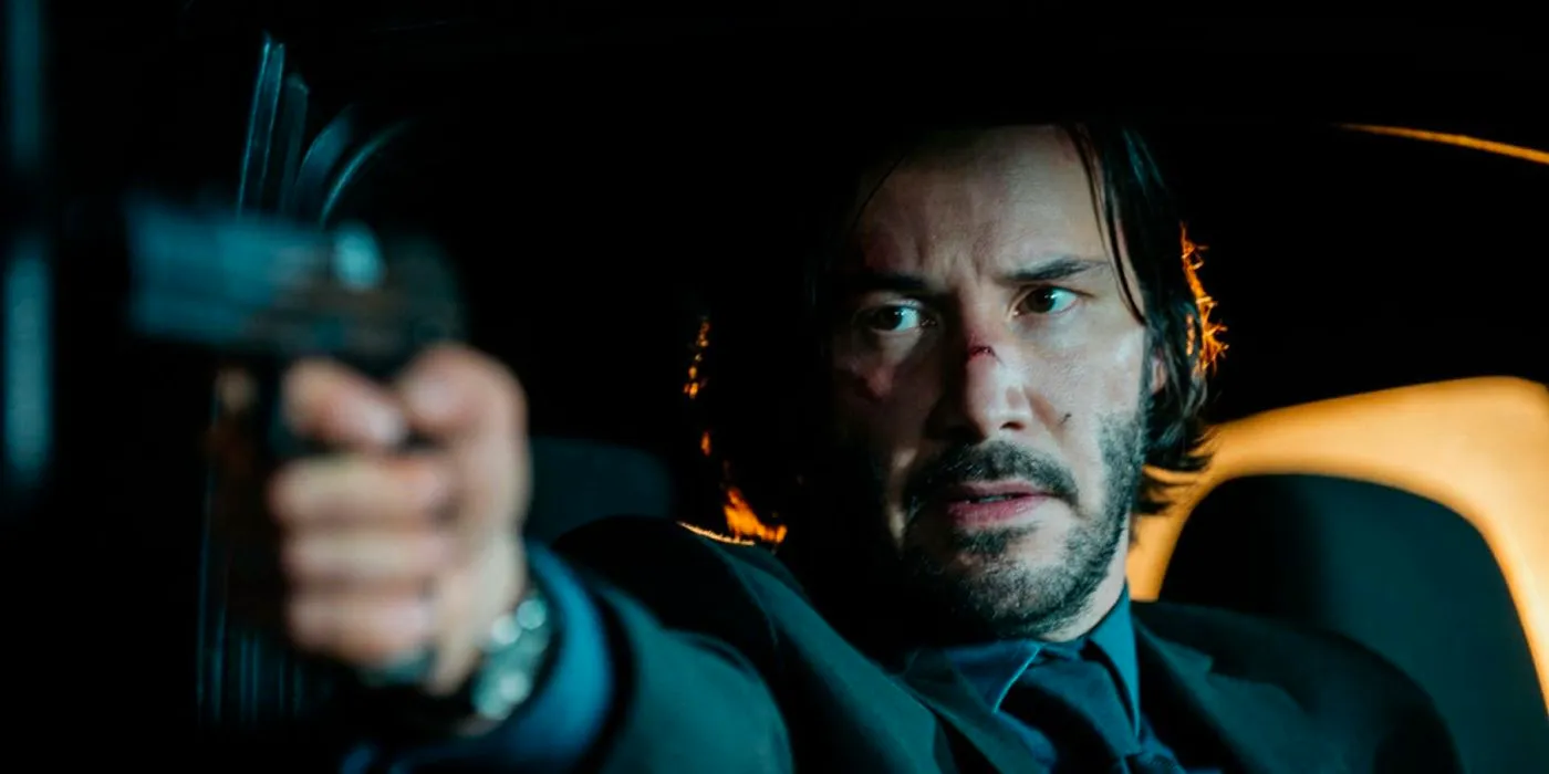 Keanu Reeves pointing a gun in John Wick. Image