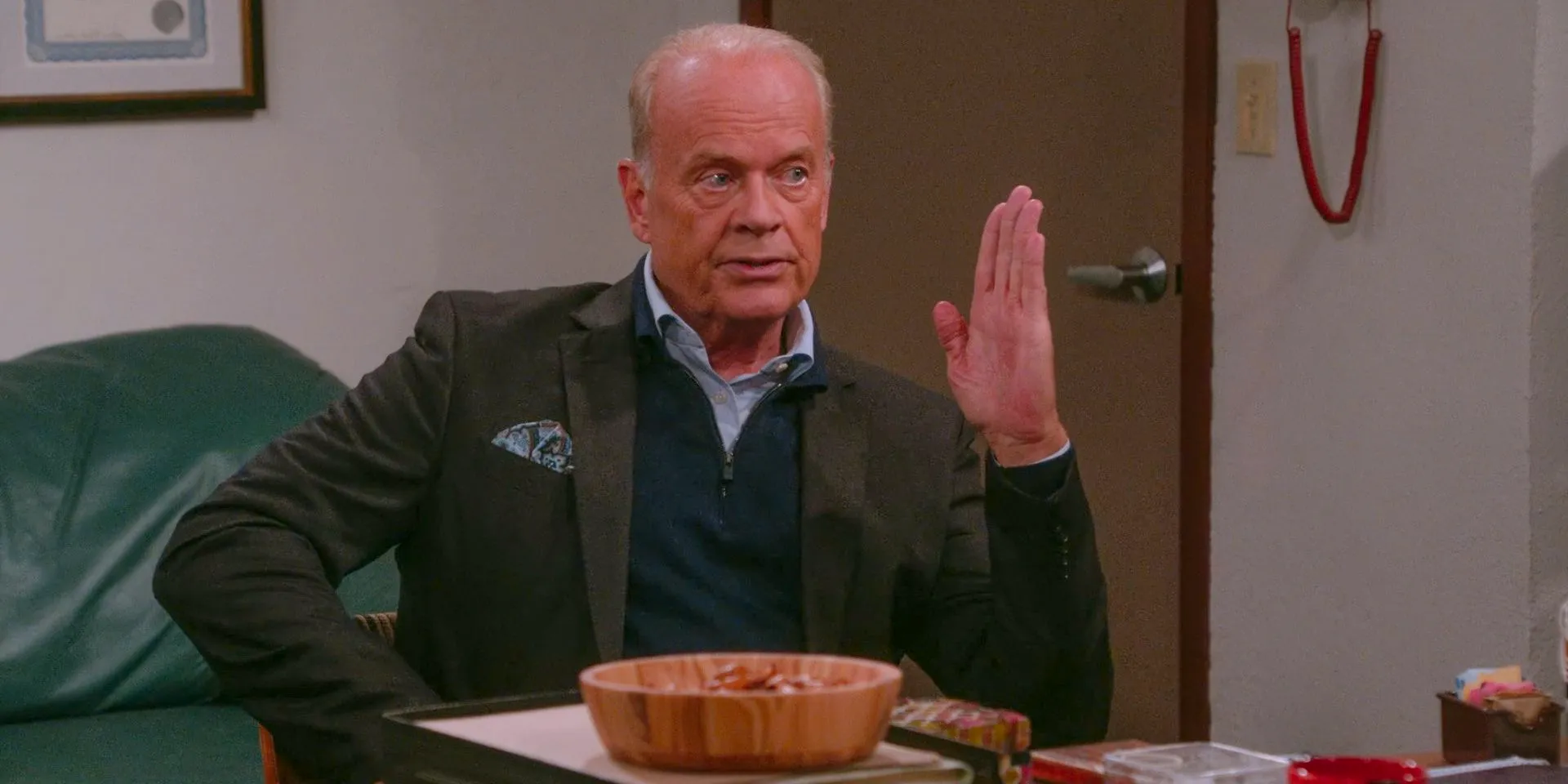 Kelsey Grammer Frasier making a blade out of his hand in Dr. Stathos' office in Frasier Season 2 Episode 4 Image