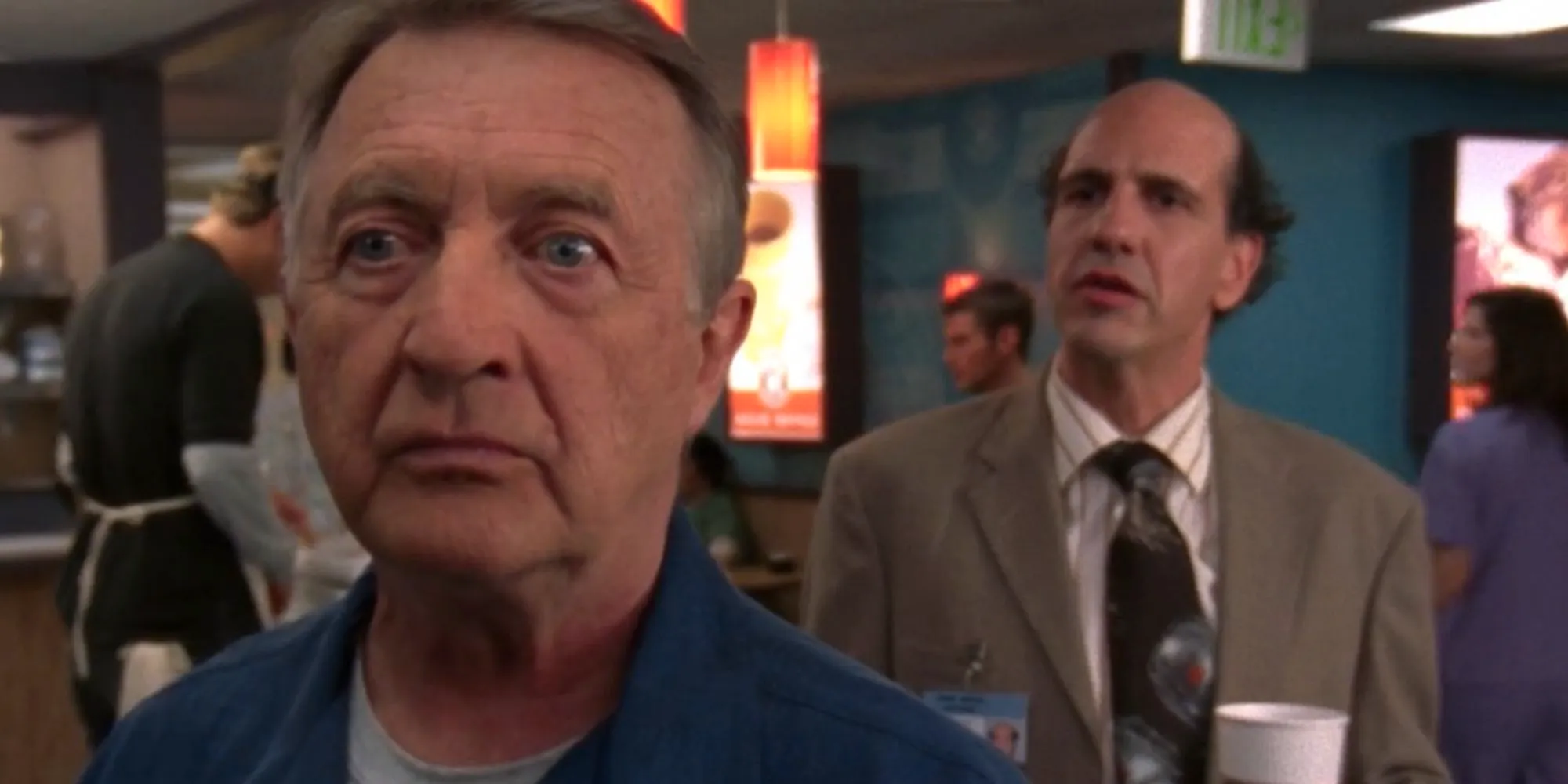 Ken Jenkins looking shocked as Dr. Kelso in Scrubs as Sam Lloyd's Ted stands behind him Image