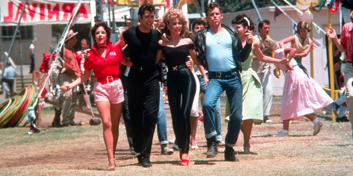 Kenickie, Sandy, Danny and Rizzo walking together in Grease Image