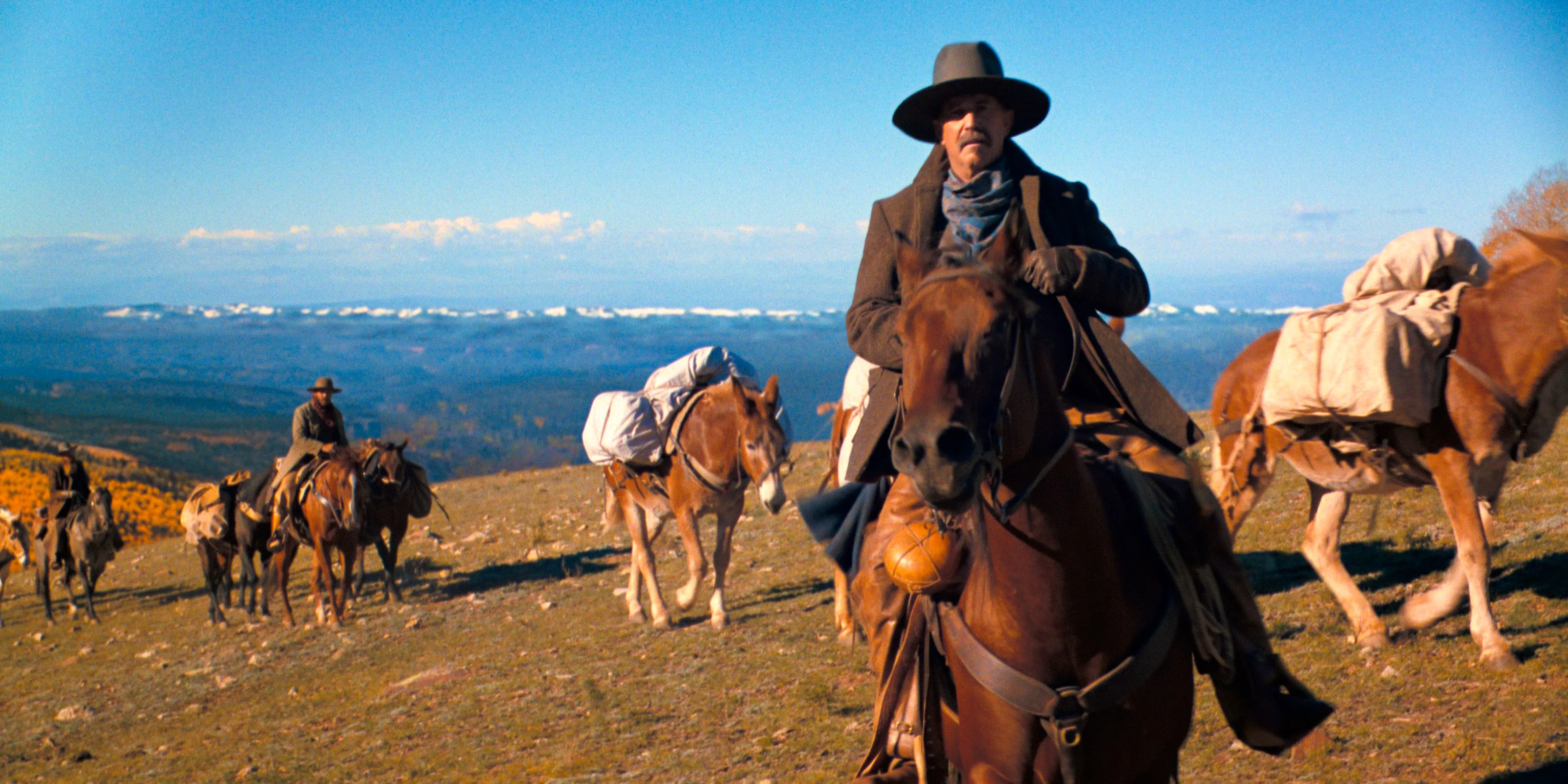 Kevin Costner on a horse leading a train of mules in Horizon Chapter 2 Image