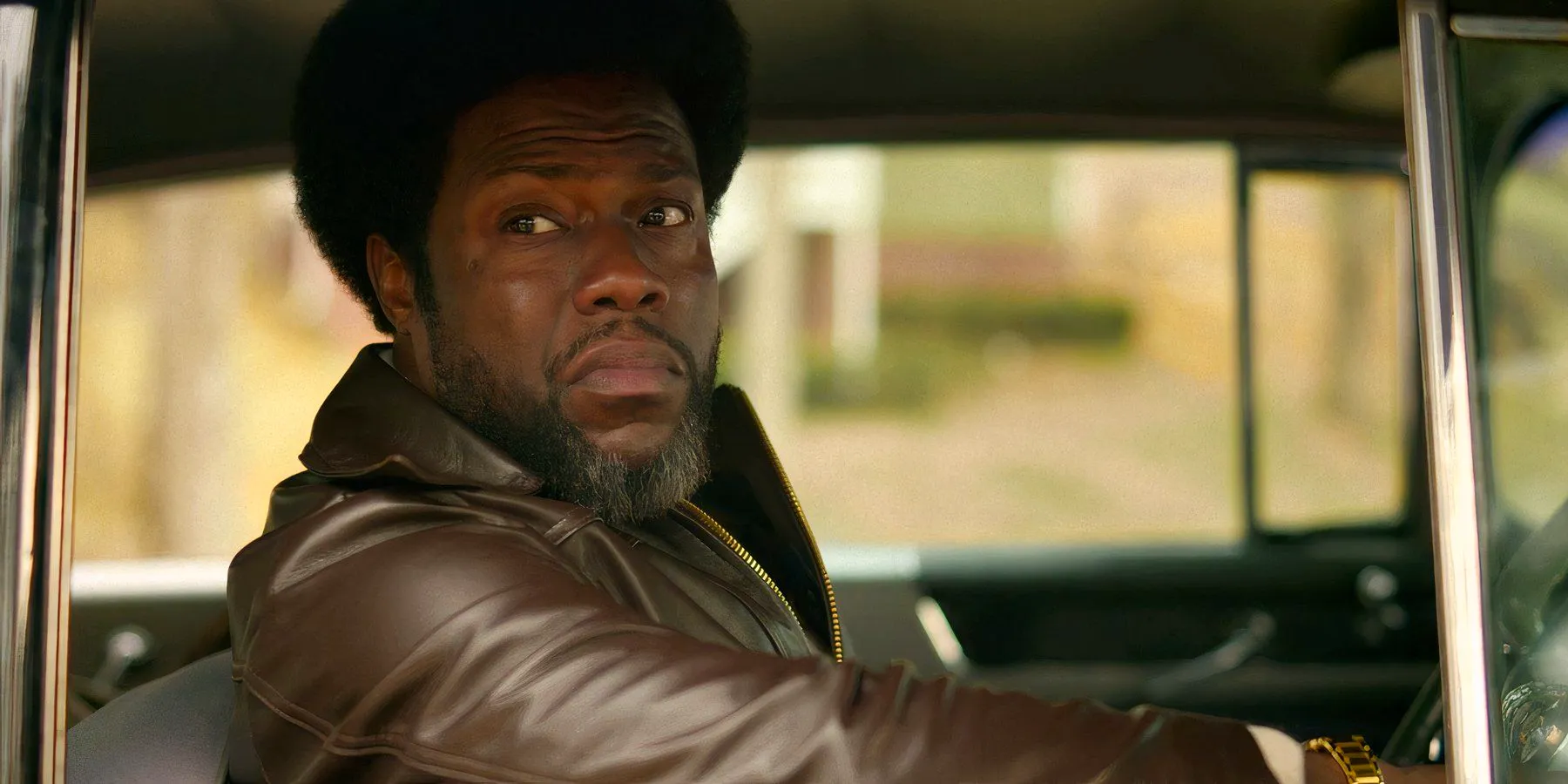 Kevin Hart's Chicken Man gazing out a car window in Fight Night Image