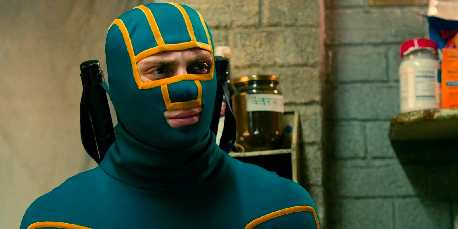 Kick-Ass (Aaron Johnson)wearing a yellow and green suit and looking confused in Kick-Ass 2 Image