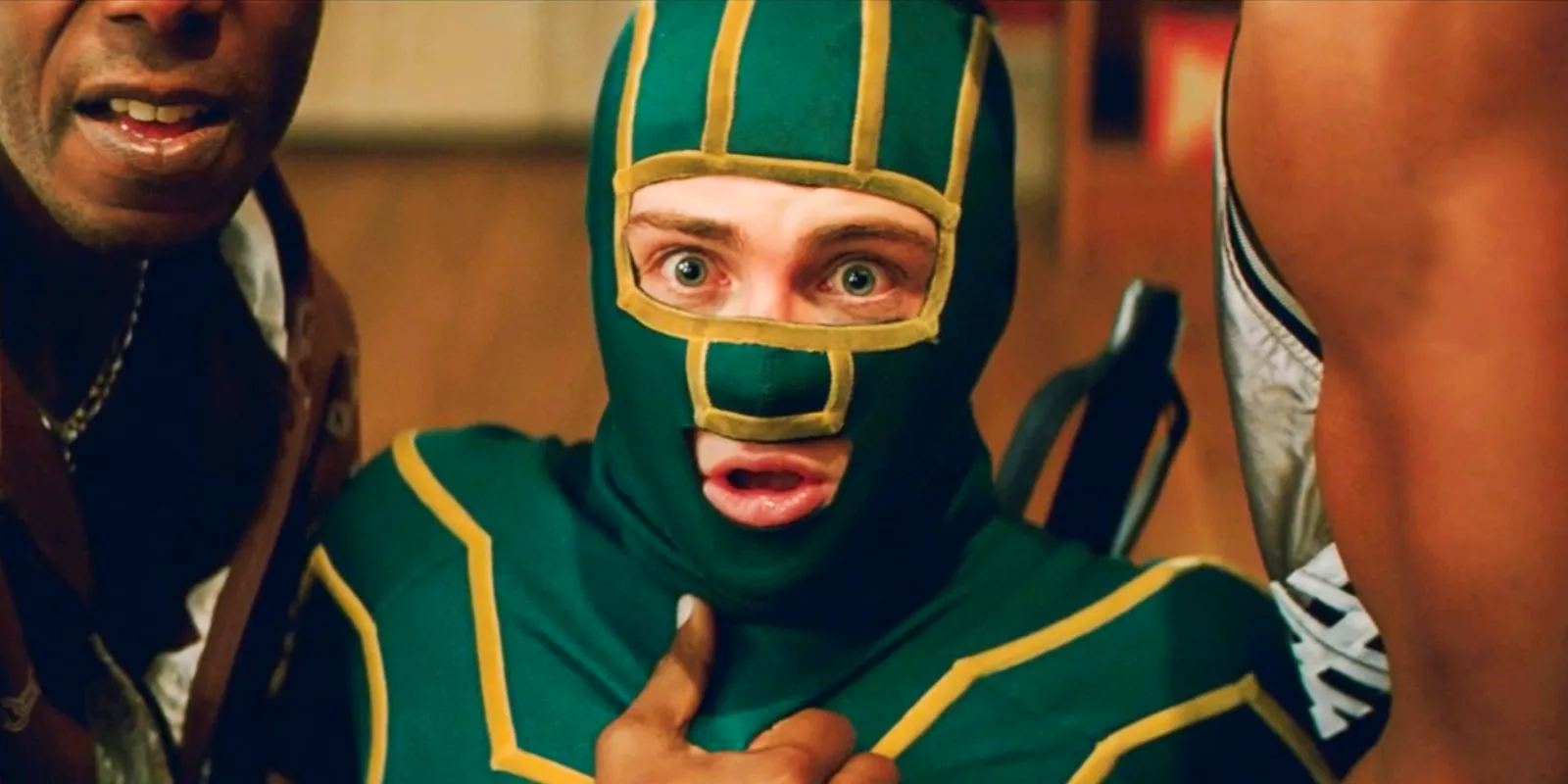 Kick-Ass (Aaron Taylor-Johnson) in costume and in trouble looking shocked Image