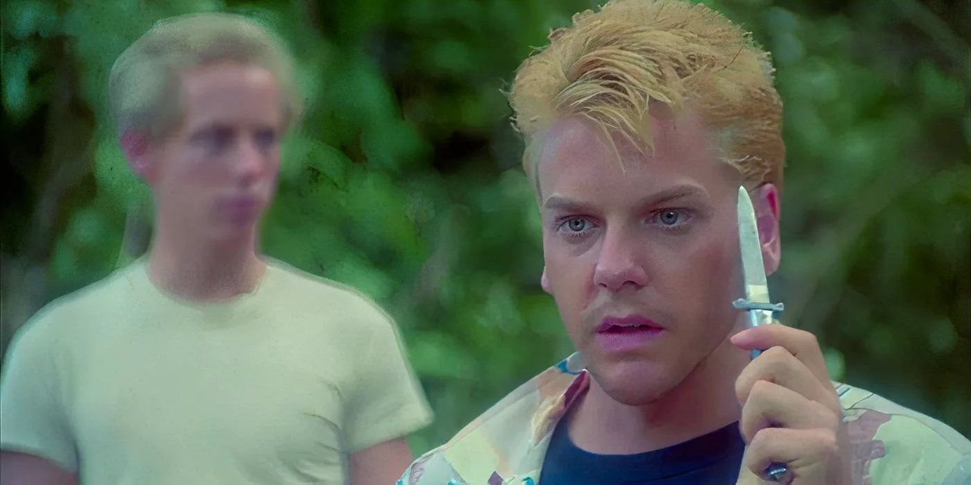 Kiefer Sutherland as Ace holding a knife in Stand by Me Image